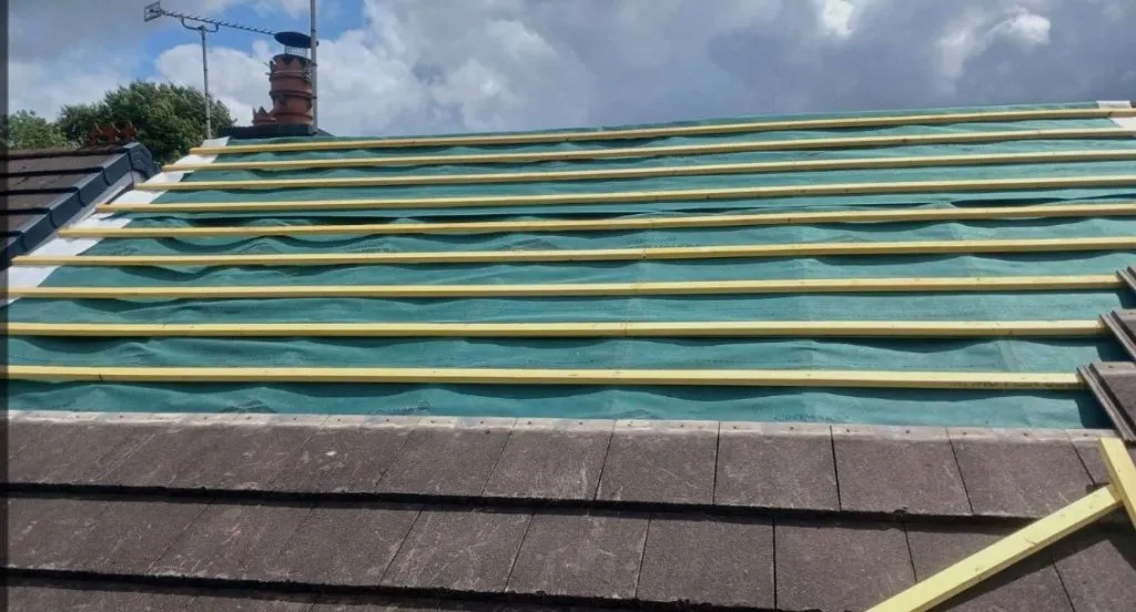 Roof replacement in progress with new breathable membrane